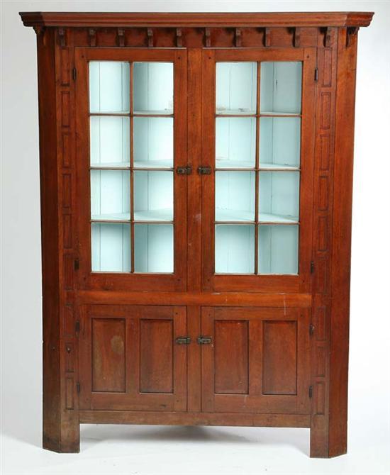 Appraisal: CORNER CUPBOARD Large walnut one-piece cupboard with molded cornice and