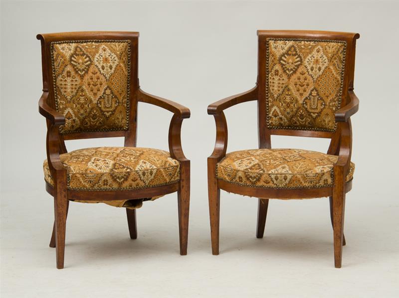 Appraisal: PAIR OF DIRECTOIRE PROVINCIAL WALNUT FAUTEUILS EN CABRIOLET Each with