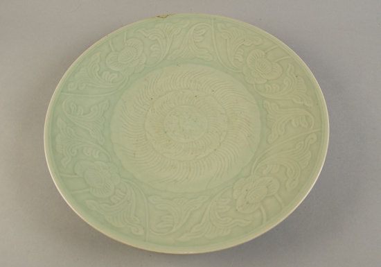 Appraisal: A Celadon Export Charger with incised floral and foliate decoration