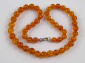 Appraisal: An amber bead necklace approx cm long beads approx mm