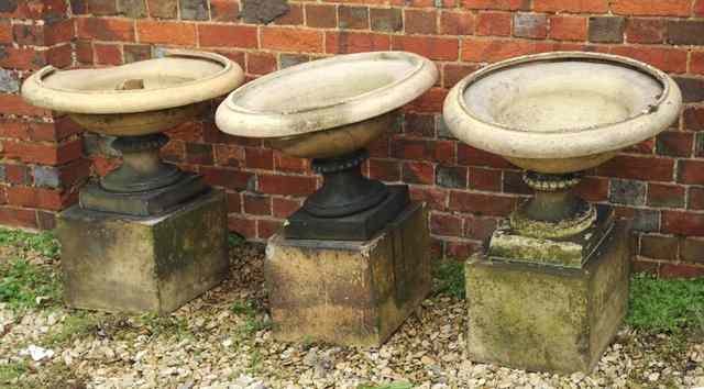 Appraisal: A SET OF THREE VICTORIAN TERRACOTTA SHALLOW URNS one stamped