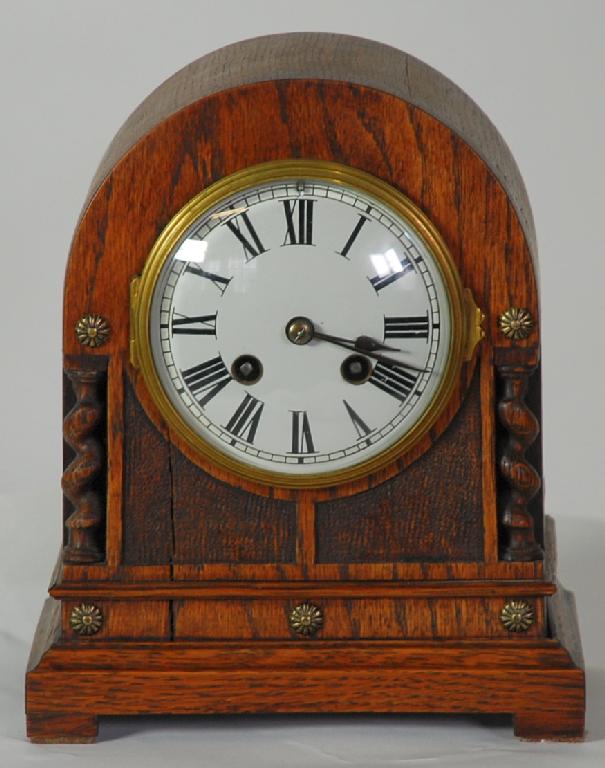 Appraisal: TWENTIETH CENTURY FRENCH OAK MANTEL CLOCK the enamelled Roman dial