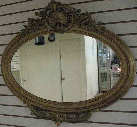 Appraisal: GILT WOOD OVAL WALL MIRROR having shell and floral crest