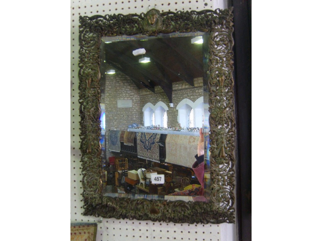 Appraisal: A th century brass framed bevelled glass mirror with elaborately