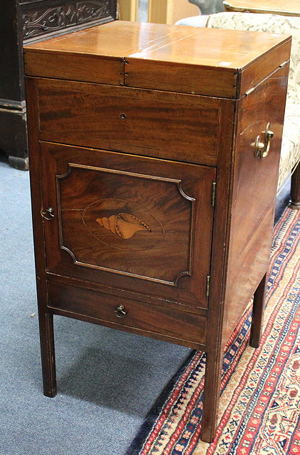 Appraisal: A GEORGE III MAHOGANY WASHSTAND the lifting top opening to