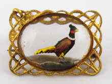 Appraisal: A crystal brooch with reverse engraving of a pheasant set