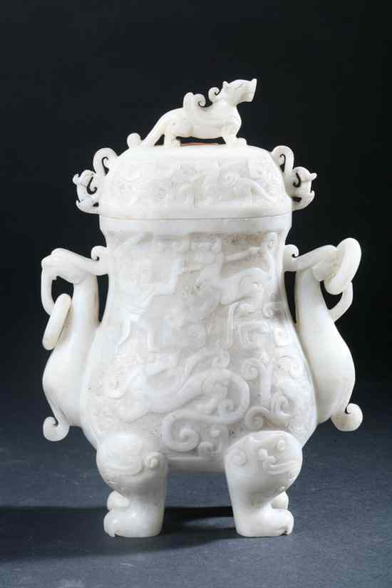 Appraisal: CHINESE ARCHAISTIC WHITE JADE VASE AND COVER Carved with mythical