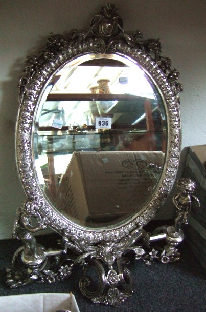 Appraisal: A plated oval toilet mirror the frame decorated with garlands