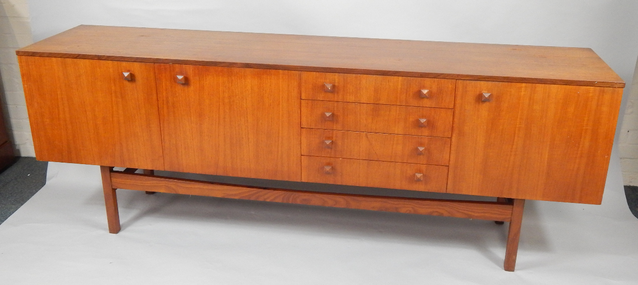 Appraisal: A Gimson Slater Vesper teak sideboard with four central drawers