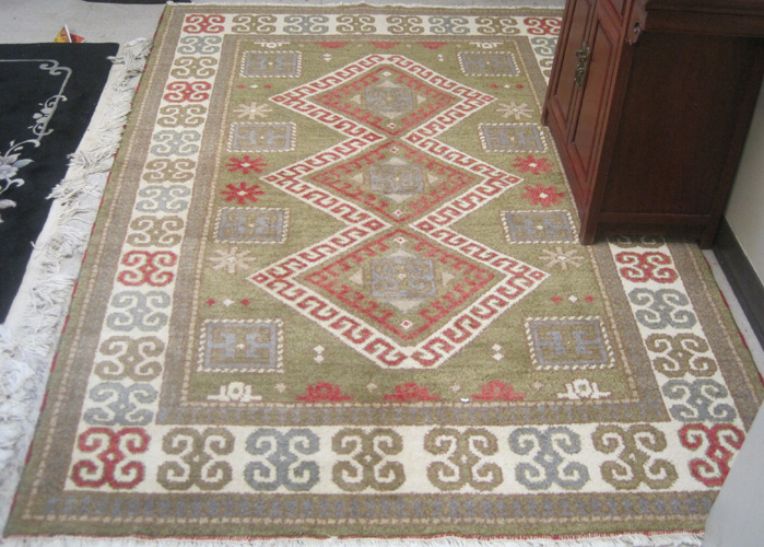 Appraisal: HAND KNOTTED ORIENTAL CARPET Indo-Kazak a three geometric latch-hook medallion