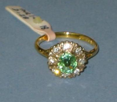 Appraisal: A GREEN TOURMALINE AND DIAMOND RING the round cut tourmaline