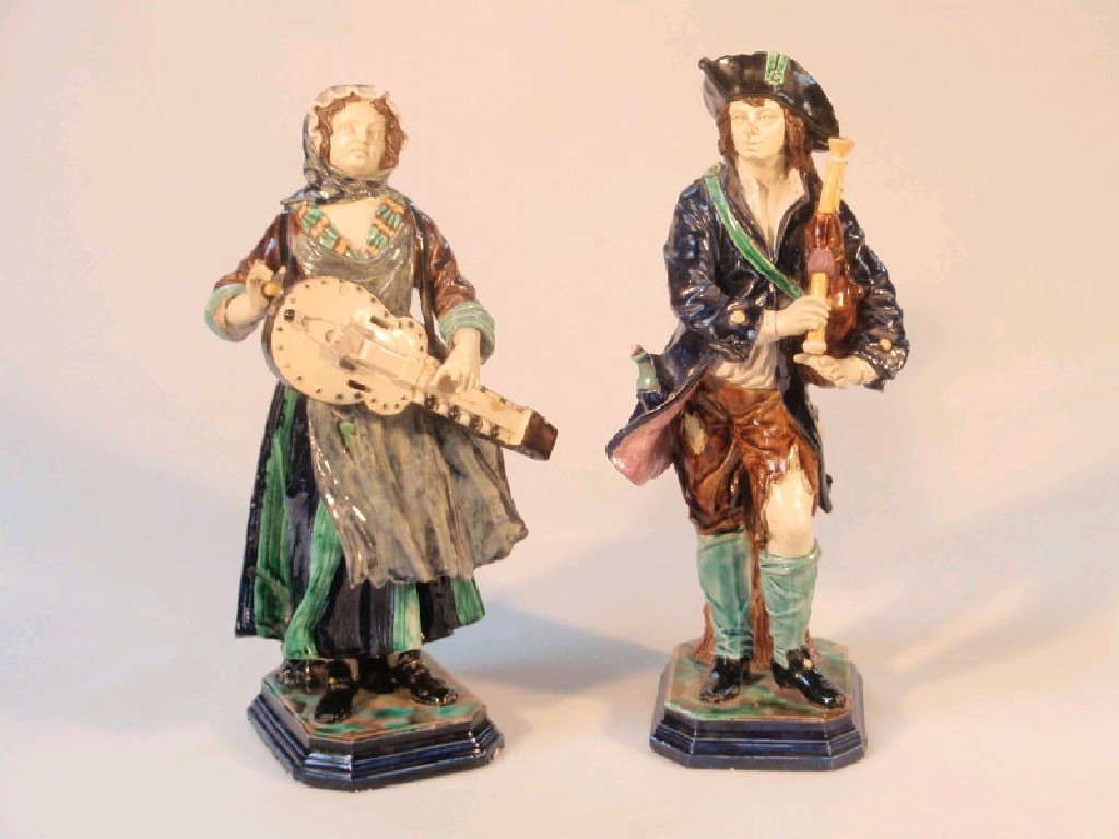 Appraisal: A pair of thC continental majolica musician figures on mottled