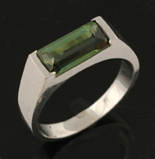 Appraisal: A tourmaline ring The rectangular step cut green tourmaline weighing