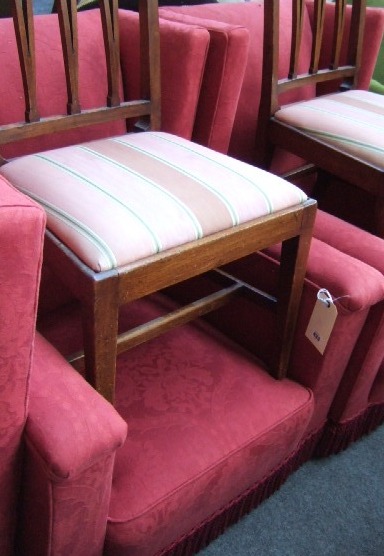 Appraisal: A pair of wing back armchairs upholstered in patterned red