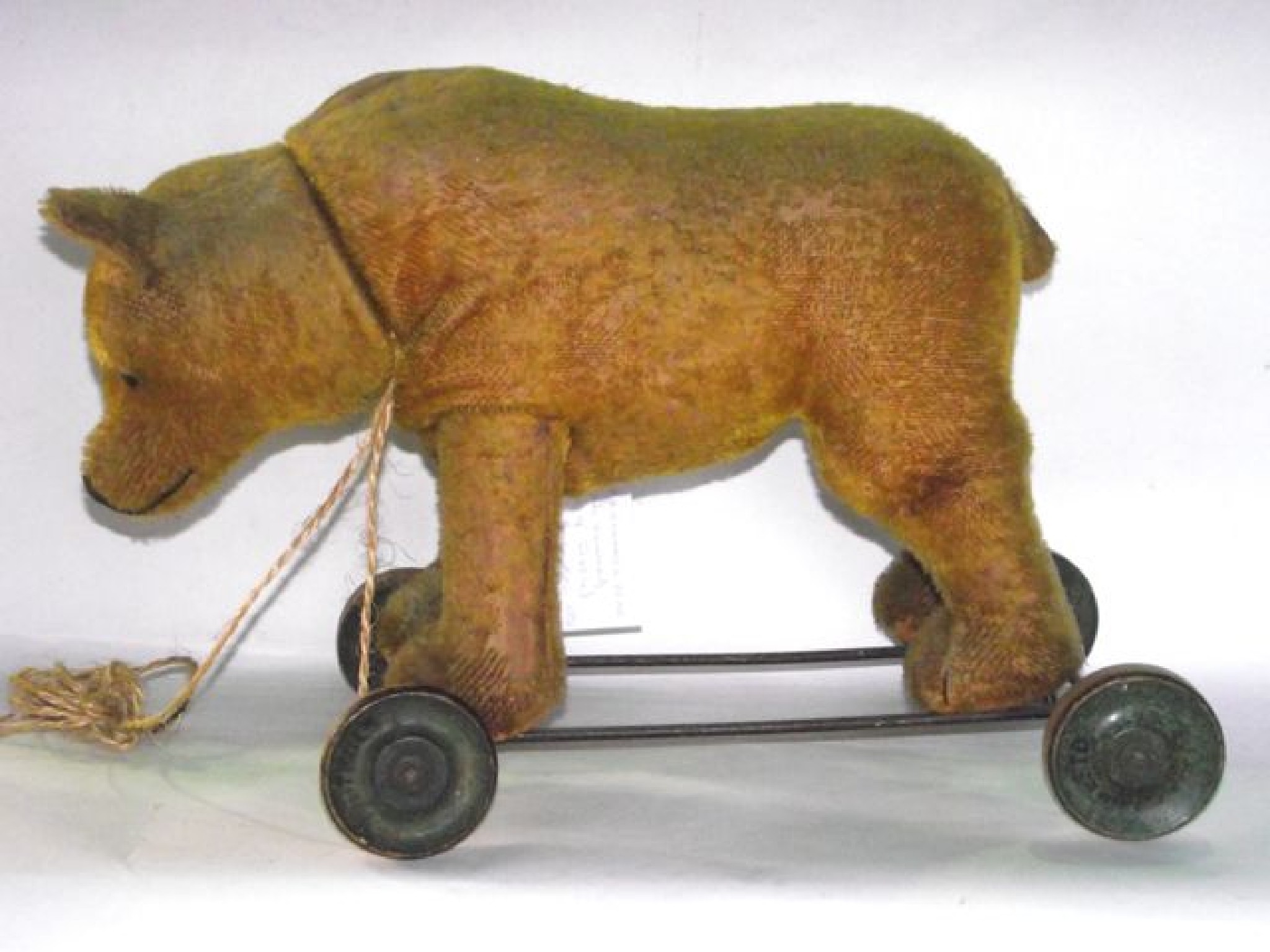 Appraisal: An early th century push along straw filled teddy bear