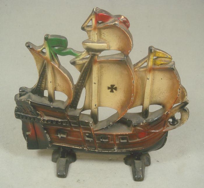 Appraisal: Cast iron doorstop brown pirate ship with multicolored flags and