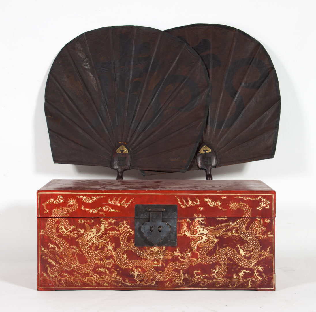 Appraisal: Chinese lacquered trunk pair of hand fans red lacquered trunk