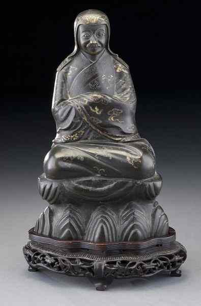 Appraisal: Japanese gold inlaid bronze immortalseated on a rock wearing a