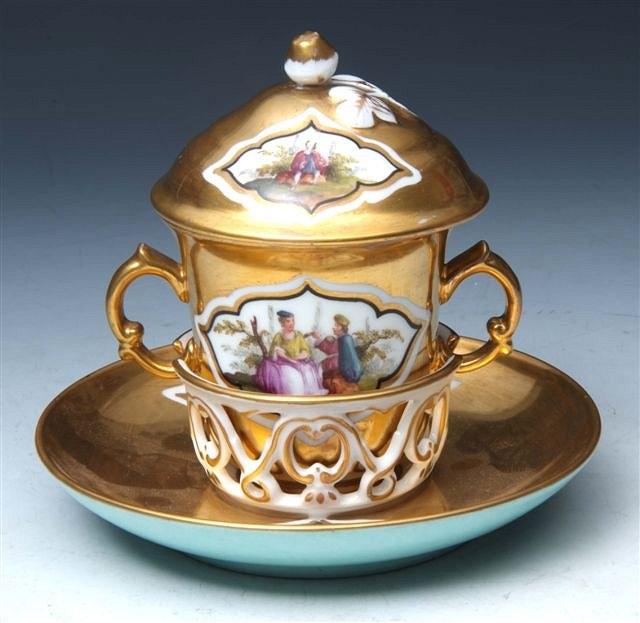 Appraisal: A HELENA WOLFSOHN GILT TREMBLEUSE COVERED CUP AND SAUCER each