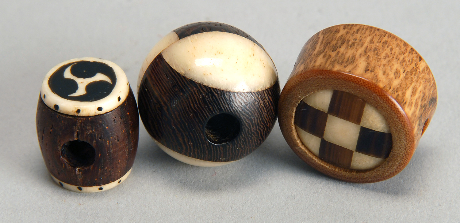 Appraisal: THREE WOOD AND IVORY OJIME In ball form drum form