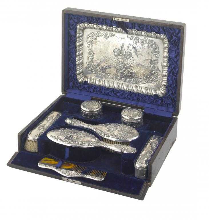 Appraisal: AN EDWARD VII BRUSH SET embossed with cherubs heads amidst