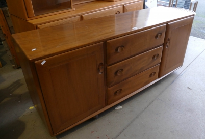 Appraisal: Mid Century Ercol light oak sideboard with drawer centre