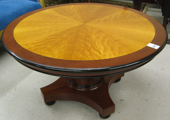 Appraisal: ROUND MAHOGANY AND RIBBON MAPLE COCKTAIL TABLE Biedermeier influence American