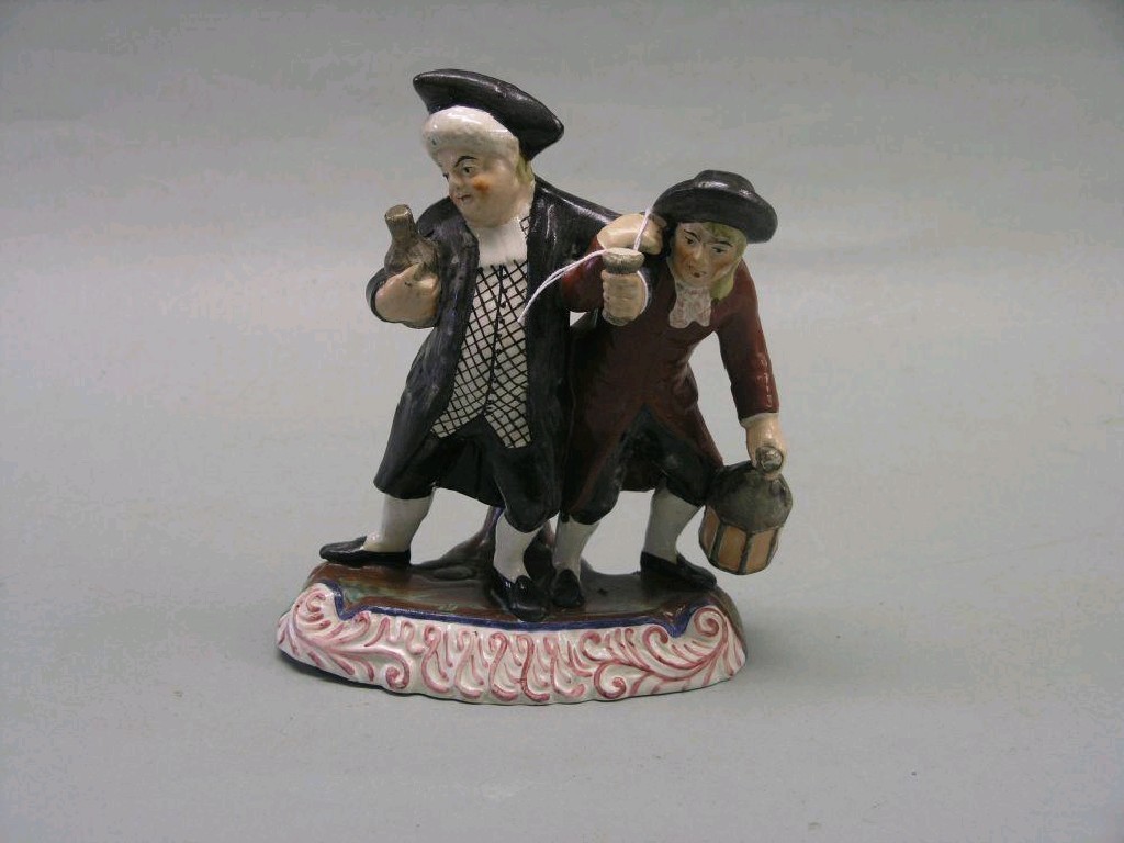 Appraisal: An early th century Staffordshire pottery figure group 'The Topers'