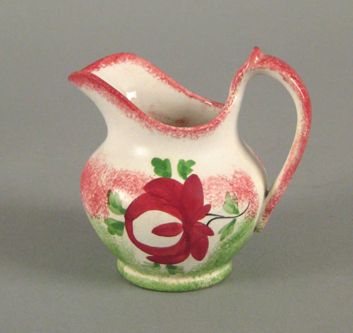 Appraisal: Red and green rainbow spatter creamer in the rose pattern