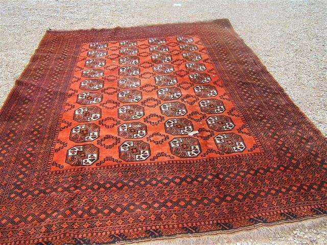 Appraisal: A wine ground Bokhara rug the central design within a