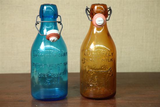 Appraisal: TWO MILK BOTTLES One amber the other blue Embossed text