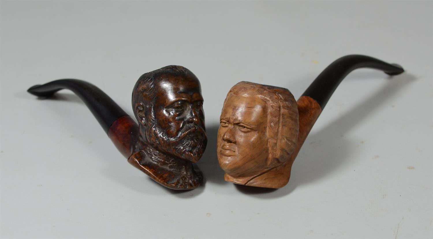 Appraisal: Group of figural carved wooden pipes man with beard and