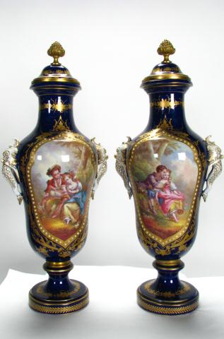 Appraisal: Pair of cobalt Sevres lidded porcelain urns with romance scenes