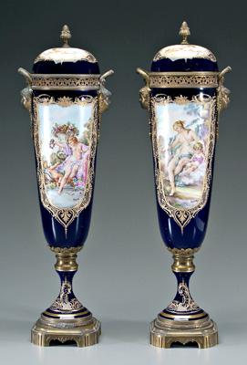 Appraisal: Pair S egrave vres porcelain lidded urns each with two