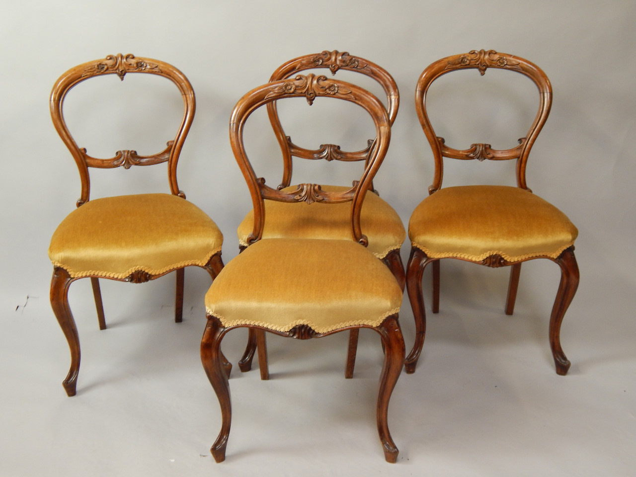 Appraisal: A set of four Victorian walnut balloonback dining chairs with