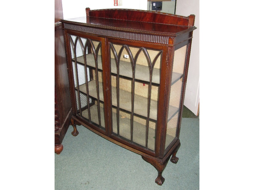 Appraisal: Mahogany display cabinet raised on ball and claw supports