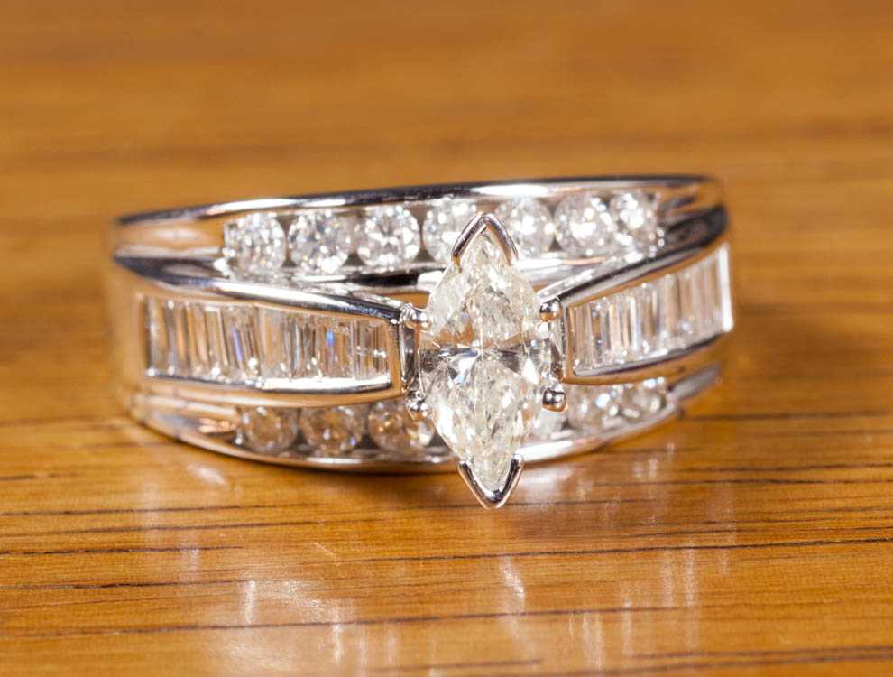 Appraisal: DIAMOND AND FOURTEEN KARAT WHITE GOLD RING channel set with