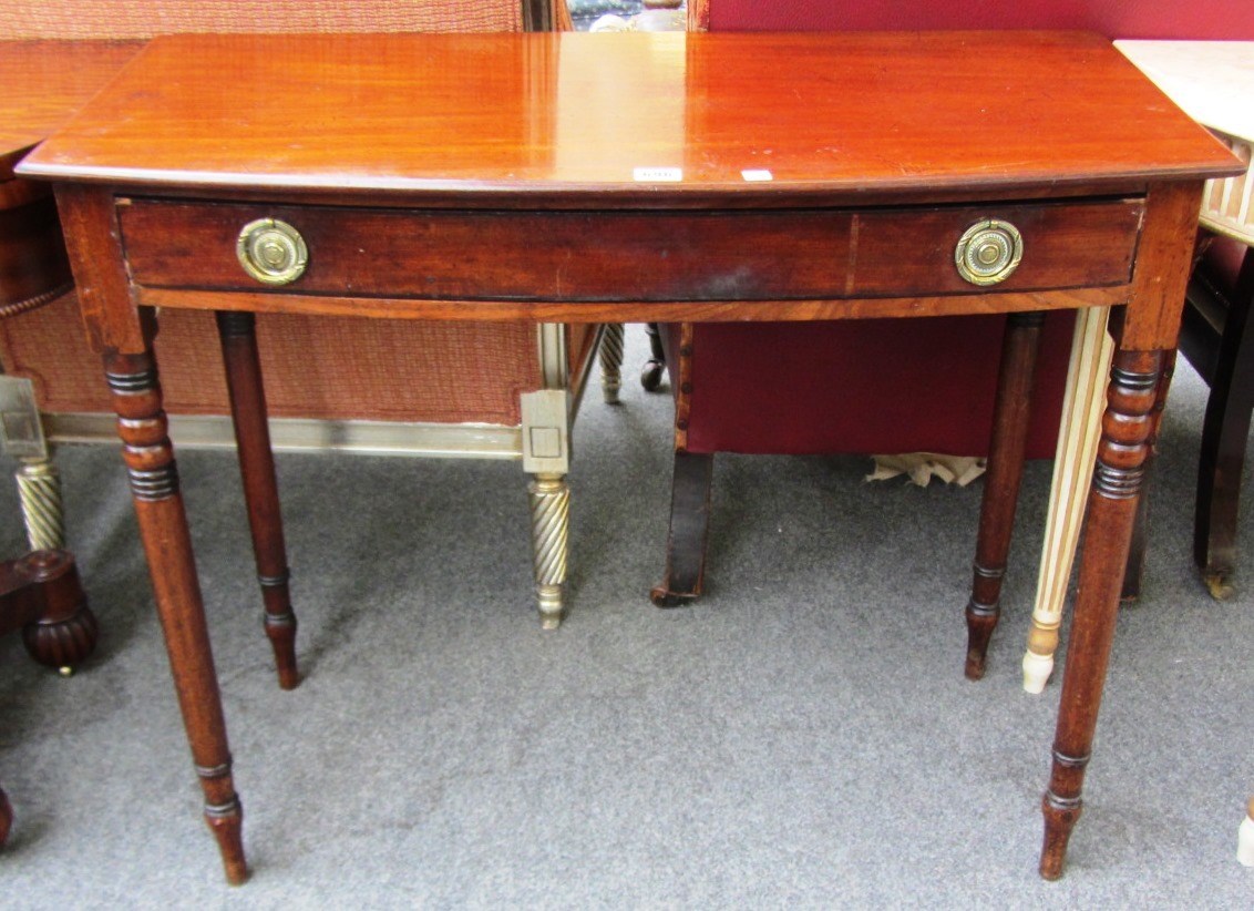 Appraisal: A th century mahogany single drawer bowfront side table on