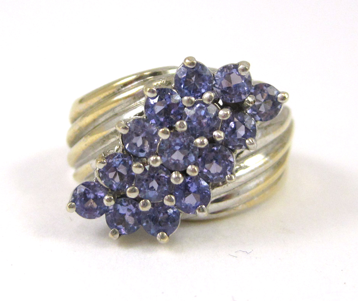 Appraisal: TANZANITE AND FOURTEEN KARAT GOLD RING set with round-cut tanzanites