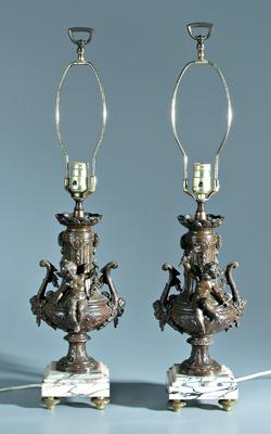 Appraisal: Pair putti figural patinated lamps urns with cupids holding torches