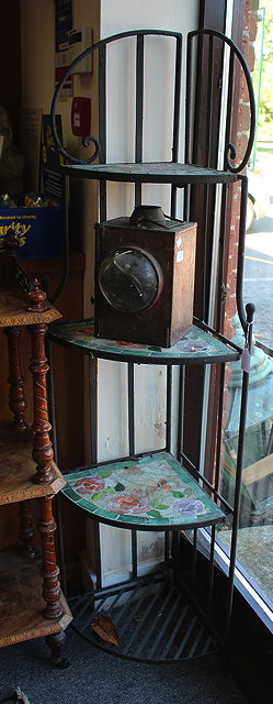 Appraisal: A WROUGHT IRON CONSERVATORY CORNER STAND the quarter round shelves