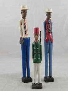 Appraisal: Three North African carved and painted figures two European tourists