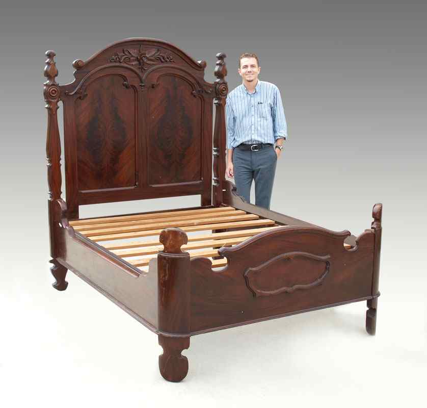 Appraisal: VICTORIAN DOUBLE PANEL BUTTERFLYED FLAME MAHOGANY VENEER BED Arched crest