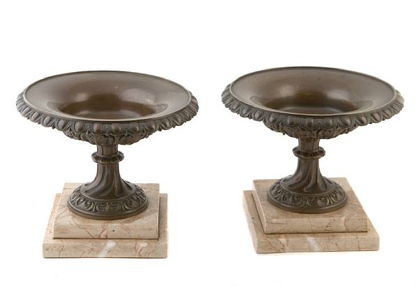 Appraisal: A pair of patinated bronze urns on marble plinths height