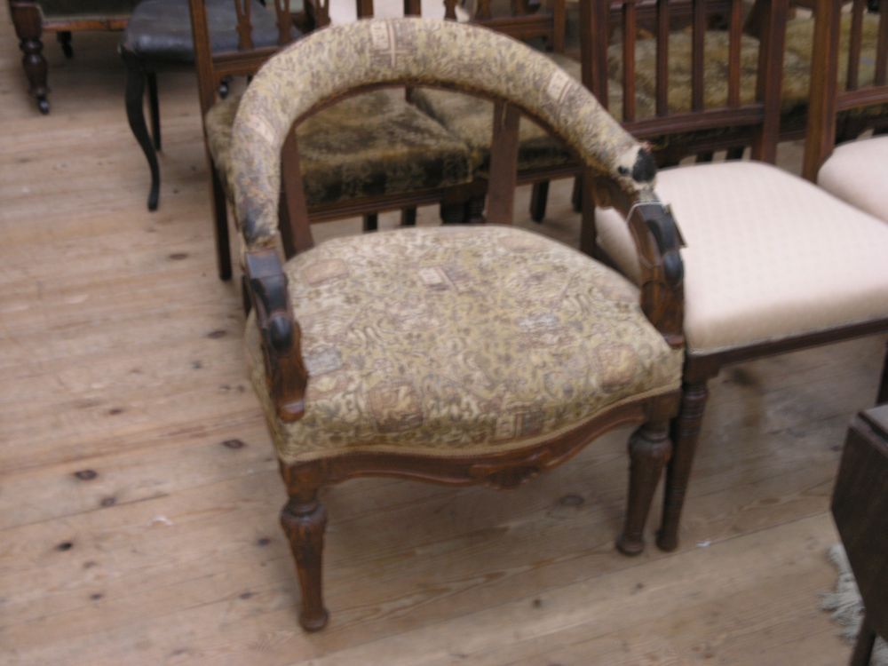 Appraisal: A Victorian oak drawing room armchair with rounded back and