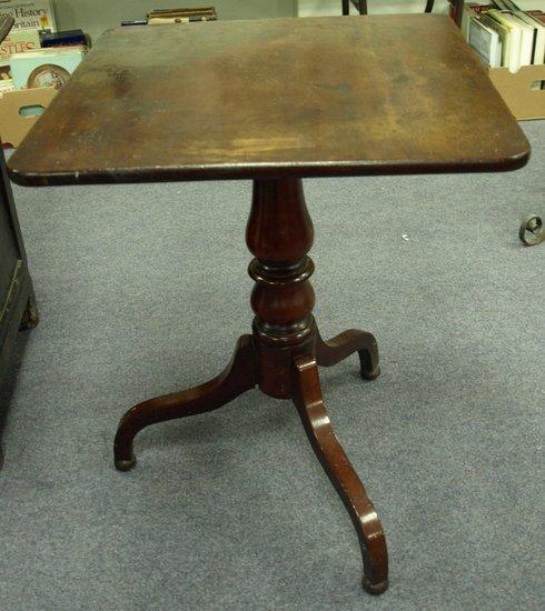 Appraisal: A mahogany tripod table the square top on a turned