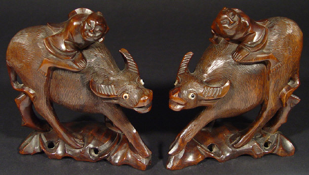 Appraisal: Pair of Chinese carved hardwood water buffalo mounted with figures