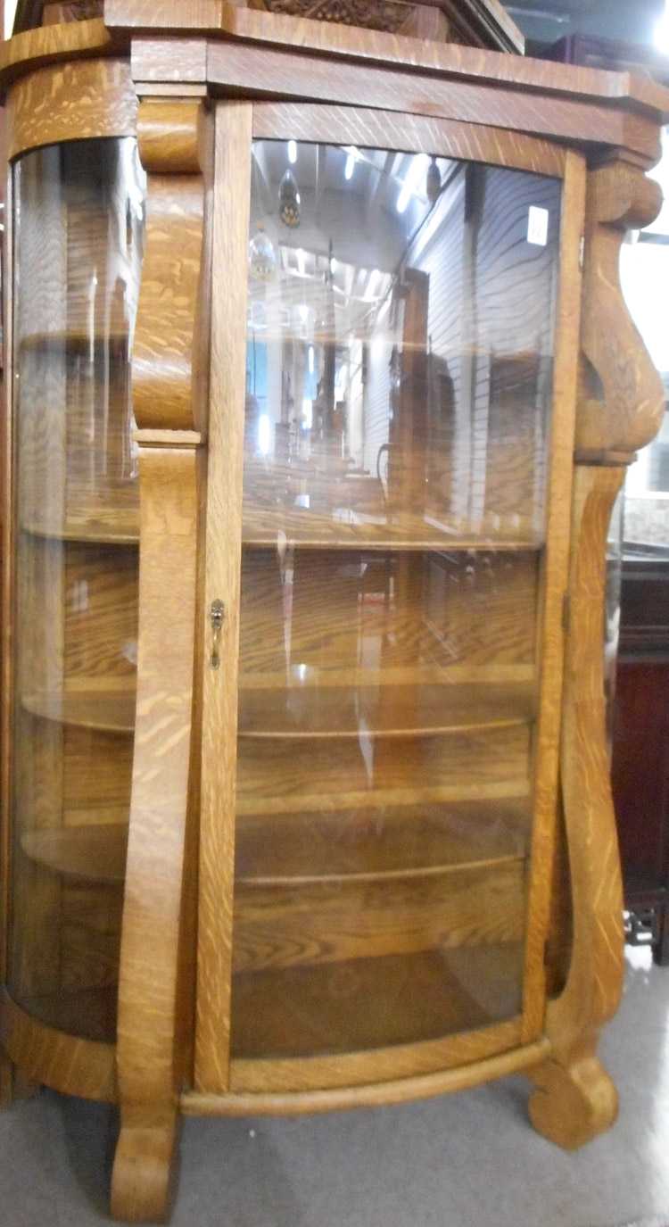 Appraisal: AN OAK AND CURVED GLASS CHINA CABINET Empire Revival style