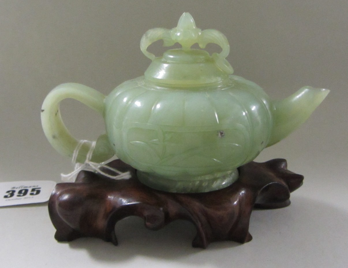 Appraisal: A Chinese jade teapot and cover th century the compressed