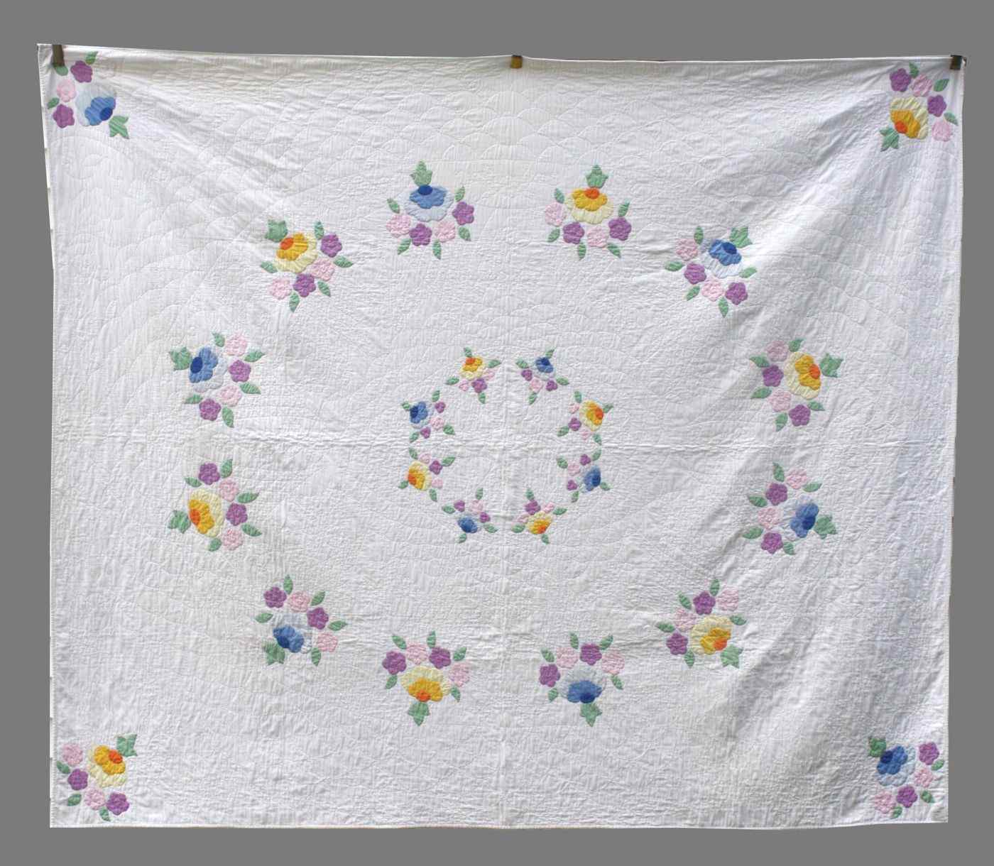 Appraisal: HAND-STITCHED APPLIQU COTTON QUILTAmerican Circa With pastel flowers leaves diamonds